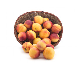Ripe fruit in basket isolated on white