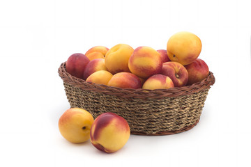 Ripe peach fruit isolated in basket on white background