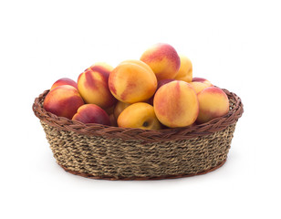 Ripe peach fruit isolated in basket on white background