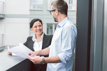 Happy smiling real estate agent near man