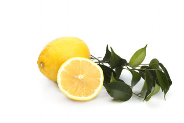 Lemon with green leaves on a white background