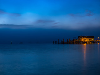 Boathouse and jetty on a misty morning