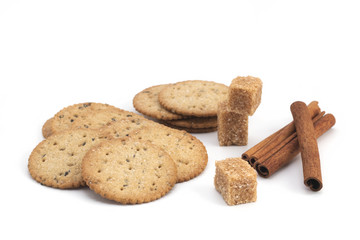 Cookies, sugar and cinnamon on a white background