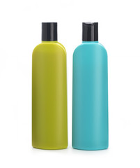 Colored bottles for shampoo on a white background