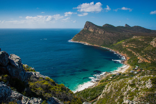View from a mountain onto the clear blue water of Smitswinkel Bay, near Cape Point, South Africa