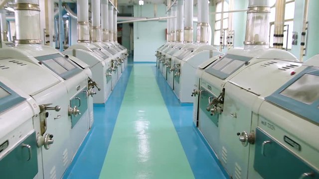 Flour mill. Manufacture of flour and cereals. Wheat milling. Production of wheat flour. Wheat flour milling equipment at the plant. Grain equipment.