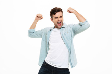 Portrait of a satisfied young man celebrating success