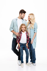 Full length portrait of a young beautiful family standing together