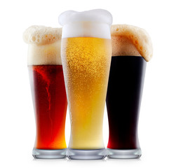 Mug collection of frosty dark red and light beer with foam isolated on a white background