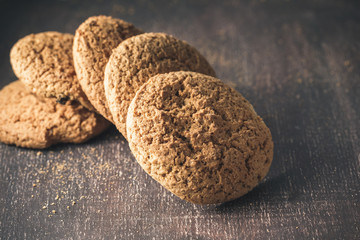 Oat cookies on brown rustic wood with copy space