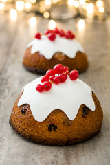 Christmas pudding and christmas light on wooden table

