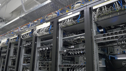 Device for mining crypto currency. Row of bitcoin miners set up on the wired shelfs. Mining cryptocurrency. Bitcoin farm. Machines for mining cryptocurrency, bitcoin. Electronic device at day