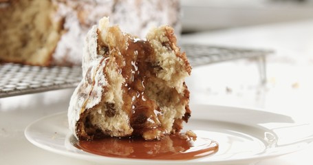 brioche in sunlight with a caramel pouring on it