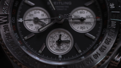 Closeup view of luxury man's wristwatch. Detail of a luxury watch on black background. Selective focus, shallow depth of field. Man's wristwatch macro