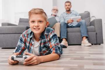 Little boy playing videogames with gamepad