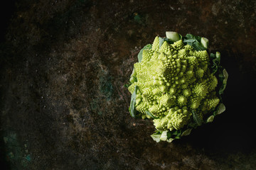 Fresh raw organic cabbage romanesco over dark texture background. Top view with space. Healthy eating concept