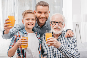 Smiling family holding glasses of juice