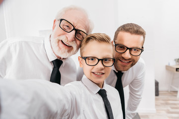 Family in formal wear taking selfie