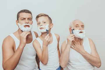 Three men shaving