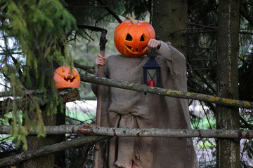 horror pumpkin with a scythe 