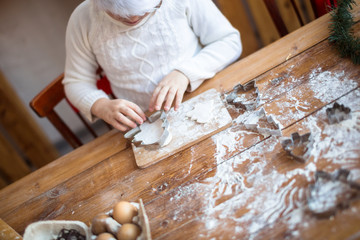 funny child girl preparing cookies, lifestyle, real nordic interior, rustic style, the brown