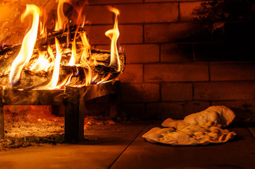 Traditional Pizza oven, burning wood and flames in fireplace. Arabic Bread Oven. Fresh and crunchy...