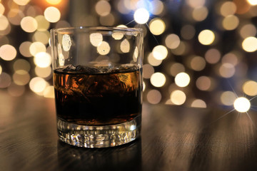 glass of cold alcohol drink with ice on table