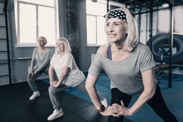 Three senior woman doing stretching together