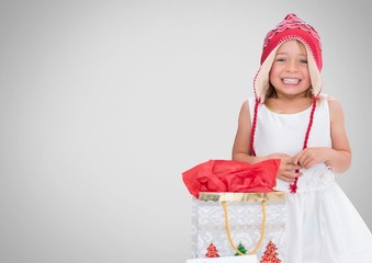 Girl against grey background with Christmas gift bag