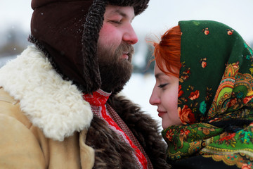 Couple in traditional winter costume of peasant in russia