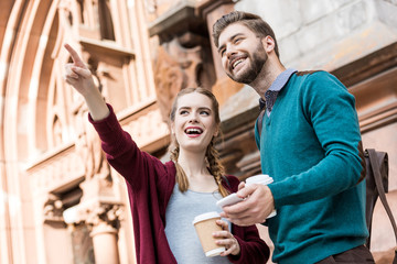 couple with coffee to go on street