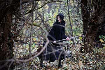 A woman in a witch suit in a forest