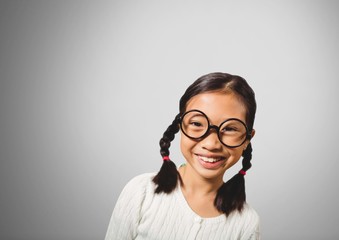 Girl against grey background with glasses