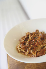 Beef stew spaghetti on wood background