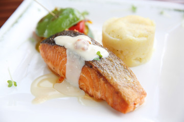 Baked salmon , salmon steak with potatoes on white wine sauce