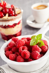 Bowl of fresh raspberries with mint leaf