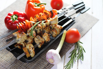Kebab cooked on metal skewers with vegetables