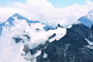 View of beautiful landscape in the Alps with snow-capped mountain tops.