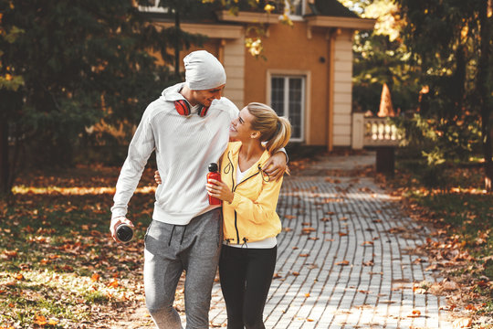 Young Couple Going To Jogging.They Just Came Out From They Home.Autumn Day.