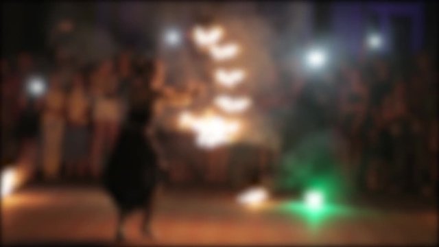 Amazing fireshow by young woman and man on a street.