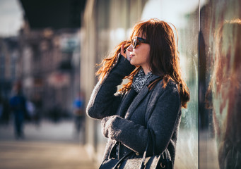 Girl on the street using mobile phone