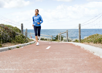 Young Woman Jogging On The Beach