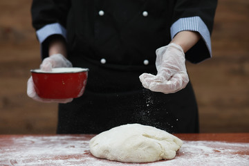the cook makes flour for baking on the table
