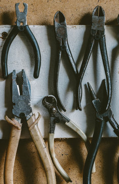 Old pliers on a wall in workshop