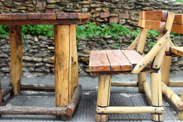 Wooden benches and table from logs in street cafe