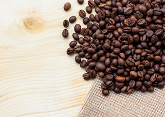 Roasted coffee beans on wooden background