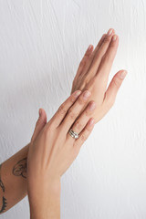  female hands on a light background