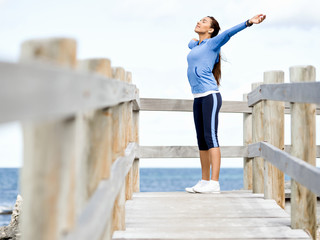 Young woman at the beach doing exercises