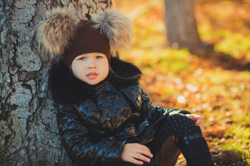 Dolly pin-up toothsome young girl wearing fashion stylish black coat jacket and awesome hat clothes posing in autumn spring park weekend happyly smiling sitting on pathway track.