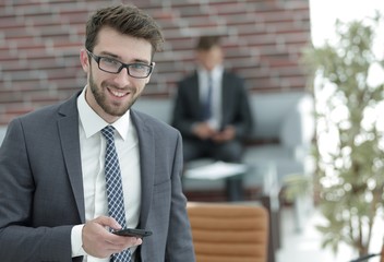 businessman with smartphone on blurred background office